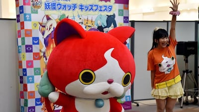 A Japanese girl with Jibanyan, one of the monsters in the Yo-Kai Watch series, which includes comics and computer games. Yoshikazu Tsuno / AFP