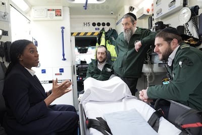 Tory leader Kemi Badenoch speaks with an ambulance crew during a solidarity visit. PA