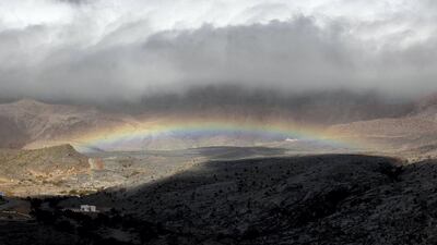 Clouds and a rainbow en route to the viewpoint of Jebel Shams, Oman. Charlotte Mayhew / The National