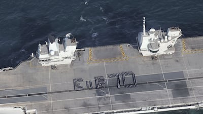 More than 300 Royal Navy sailors spell out a giant platinum jubilee greeting to the Queen from the flight deck of the aircraft carrier 'HMS Queen Elizabeth' on Tuesday. Ministry of Defence / PA