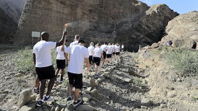 Volunteers with the Special Olympics torch “Flame of Hope” in Wadi Al Wurayah Waterfalls in Fujairah. Pawan Singh/The National