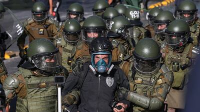 A man is detained by police during clashes with police after a protest against President Sebastian Pinera demanding the release of the anti-government protesters detained since the anti-government protests began in 2019, in Santiago, Chile. AP Photo
