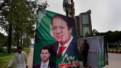 Pakistani workers install a huge billboard of deposed prime minister Nawaz Sharif by the side of a road in Islamabad, along the route of his planned rally, on August 8, 2017. Anjum Naveed / AP