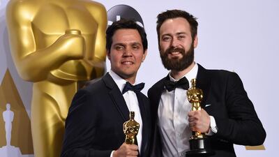 Benjamin Cleary, right, and Shan Christopher Ogilvie pose with their Oscar for Best Live Action Short Film, Stutterer, in the press room. Frederic J Brown / AFP photo