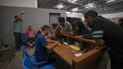 Patients register for treatment at the reception area set up in the yard of the hospital