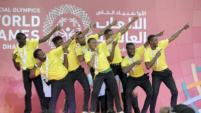 Members of the Jamacia Basketball team do the Usain Bolt pose after receiving their gold medals on Thursday. Pawan Singh / The National