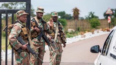Soldiers of the South African National Defence Force stop a car at the entrance of The Protea Hotel Ranch Resort in Polokwane, where the 122 South African citizens evacuated from the coronavirus epicentre of Wuhan in China are to be quarantined upon their return. AFP