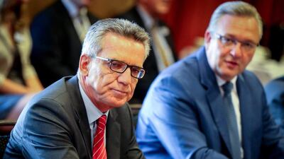 Thomas de Maiziere, left, said the full-face veil ‘does not belong in our cosmopolitan country’. Kay Nietfeld / EPA