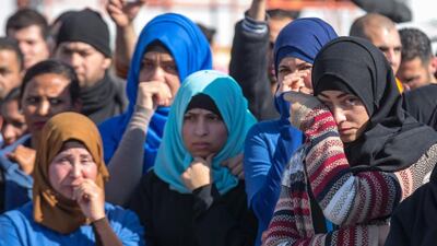 Palestinian colleagues react before the departure of the last Palestinian employees of SodaStream's Rahat factory on February 29. Jack Guez/ AFP