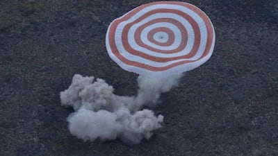 The Russian Soyuz TMA-16M space capsule, carrying the Expedition 44 crew member Gennady Padalka of Roscosmos and visiting crew members Andreas Mogensen and Aidyn Aimbetov, lands in a remote area outside the town of Zhezkazgan in Kazakhstan. Yuri Kochetkov / AFP