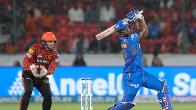 Mumbai Indians' Romario Shepherd smashes the ball on his way to a quickfire 39 runs of just 10 deliveries against Delhi Capitals. AP