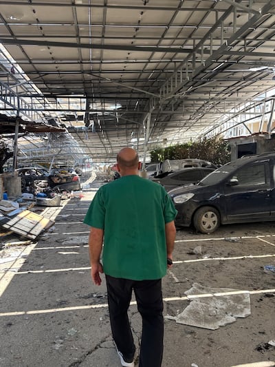 Doctor Mroueh walks through the destroyed parking lot of the Jabal Amel hospital. Jamie Prentis / The National