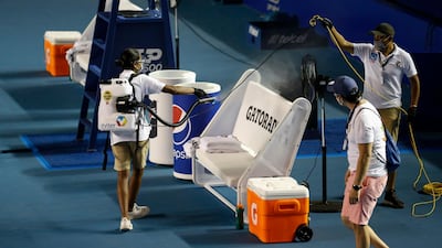 Workers spray disinfectant onto the players' benches, between second round matches at the Mexican Open tennis tournament in Acapulco. AP Photo