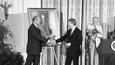 Former president Jimmy Carter shakes hands with former president Gerald R Ford during an unveiling ceremony in 1978. AP