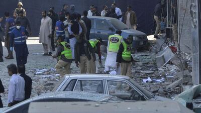 Pakistani security officials examine the site after a bomb attack in Lahore. Arif Ali / AFP