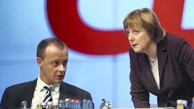 Friedrich Merz and Angela Merkel speak at the CDU party congress in December 2003 in Leipzig. Getty Images