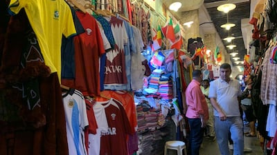 An array of football shirts from teams represented at the tournament are on sale.