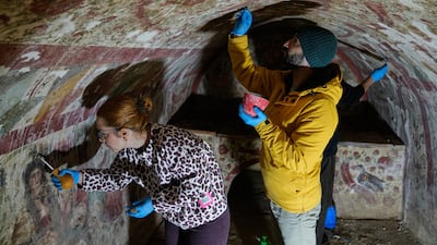 Archaeologists clean and restore frescoes inside a third-century tomb where a rare early Christian depiction of Jesus as the 'Good Shepherd' was discovered, in Iznik, Turkey. AP