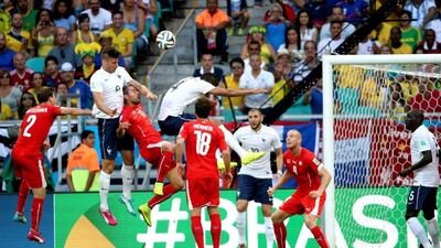 Olivier Giroud heads the ball in for France's opening goal in a 5-2 win over Switzerland on Friday at the Arena Fonte Nova during the 2014 World Cup in Salvador, Brazil. Ali Haider / EPA
