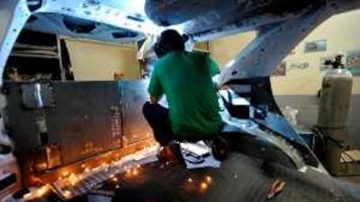 A worker melds metal plate at the rear of a vehicle at Exo Armoring in Manila. The company makes on average 40 bulletproofs cars a year.