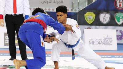 Khalifa Nassrati ( white ) of Al Ain Jiu-Jitsu Club and Abdul Rehman Alawlqi ( blue ) of Al Wahda Club during the Final game of junior under 21 category in the Jiu-Jitsu President’s Cup Round -1 held at Al Jazira Club Indoor stadium in Abu Dhabi. Khalifa Nassrati won the final game. Pawan Singh / The National