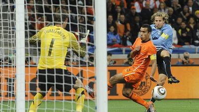 Forlan, right, in action for Uruguay against the Netherlands during the Fifa World Cup 2010 semi-final on 06 July 2010. Forlan would end the tournament as the top-scorer. Helmut Fohringer / EPA