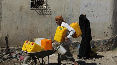 Yemenis wait to collect drinking water from a donated water pipe in the capital, Sanaa, on November 18, 2017. Yahya Arhab / EPA