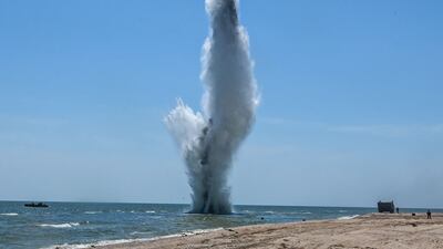 Russian troops demine the bay and beach of Mariupol, Ukraine. AFP