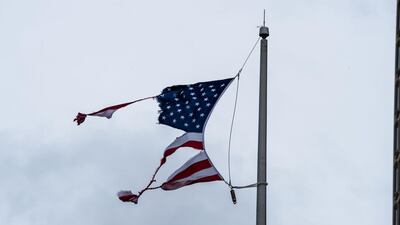 A torn US national flag is seen during Hurricane Sally landfall in Mobile, Alabama. AFP
