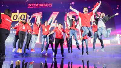 Alibaba staff celebrate sales after the end of the Singles Day shopping festiva in Shangha. AFP