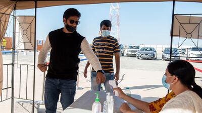 People have their temperatures checked before entering the construction site of the UAE’s first traditional Hindu temple, in Abu Dhabi. All Photos by Vidhyaa Chandramohan for The National