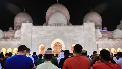 Worshippers offer isha prayers at the Sheikh Zayed Grand Mosque in Abu Dhabi. Victor Besa / The National