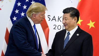 Mr Trump, left, with Chinese president Xi Jinping. The trade war between the world's two largest economies dampened economic growth this year. AFP