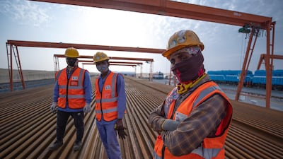 Railroad workers preparing tracks at the depot. Victor Besa / The National