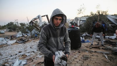 A Palestinian boy stands amid the wreckage of an Israeli air strike on an encampment in Al Mawasi, southern Gaza, on Thursday. Reuters