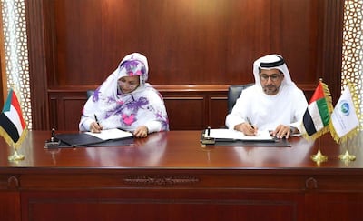 Abu Dhabi Fund for Development Director General Mohammed Saif Al Suwaidi and Amna Mirgani Hassan from the Sudan Central Bank sign the agreement. Courtesy Abu Dhabi Fund for Development