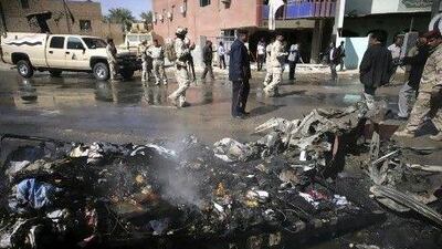 Iraqi security forces inspect the site of a bomb attack in the Shiite holy city of Karbala, south of Baghdad, today.