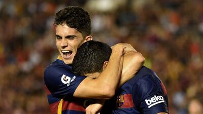 Luis Suarez of Barcelona is congratulated by teammate Marc Bartra after his goal against LA Galaxy on Tuesday in a pre-season friendly. Mark Ralston / AFP