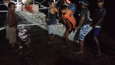 Passengers are rescued from the boat. EPA