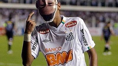 Brazil's Santos Neymar wears a mask depicting himself in celebration after scoring the third goal of his team against Chile's Colo Colo in Santos, Brazil. Andre Penner / AP Photo