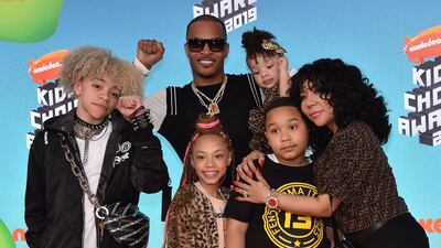 US rapper T.I., centre, wife singer-songwriter Tiny, right, and their children arrive. AFP