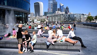 People enjoy the summer weather in London in June. While the UK government plans to lift lockdown restrictions completely on June 21, the final decision rests on hospital admissions and death rates. EPA