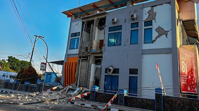 Rubble lies on a road in Ruteng, East Nusa Tenggara, after the deadly tremor. AFP