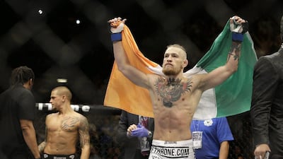 Conor McGregor displays the Irish flag after beating Dustin Poirier on Saturday in a featherweight fight at UFC 178. AP
