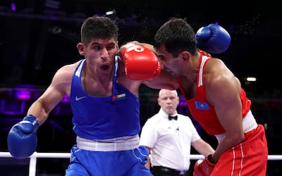 Jordan's Zeyad Ishaish, right, beat heavy favourite Aslanbek Shymbergenov in his opening bout in the men's 71kg division. Getty