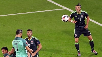 Cristiano Ronaldo (L) of Portugal scores the 1-0 lead next to Gareth Bale (R) of Wales during the Uefa Euro 2016 semi-final match between Portugal and Wales at Stade de Lyon in Lyon, France, 06 July 2016. Srdjan Suki / EPA