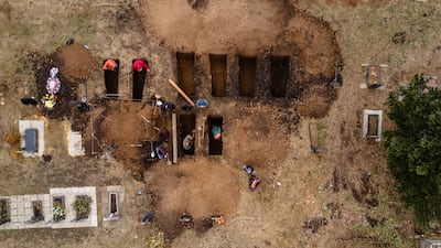 Gravediggers make new graves for the victims of a recent Russian missile strike, at Hroza cemetery, in October 2023. Getty Images