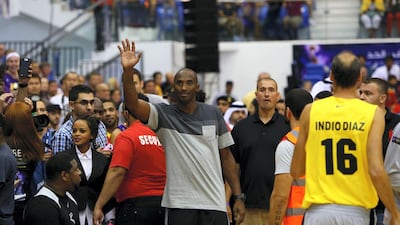 LA Lakers NBA player Kobe Bryant salutes the crowds as he arrives to American University of Dubai basketball court to coach a team made up of local celebrities on September, 27, 2013. AFP