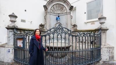 Ms Lahbib with the iconic Manneken-Pis, known as Manneken-Peace, dressed in a NATO uniform, in Brussels. PA