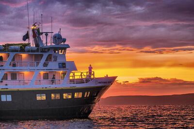 The Lindblad Expeditions ship National Geographic Sea Lion at sunset off Isla Ildefonso, Baja California Sur, Mexico. Michael S Nolan / Lindblad Expeditions - National Geographic